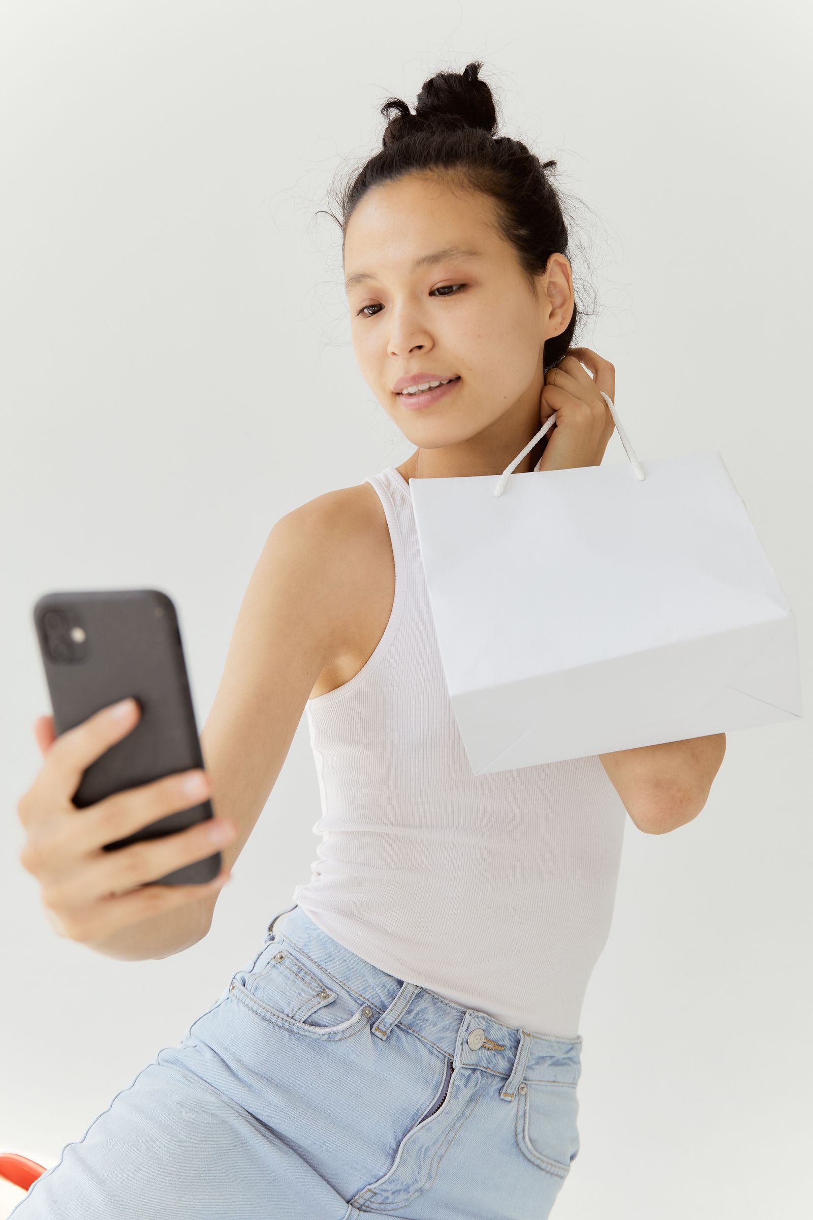 Creator taking a photo of herself with her smartphone